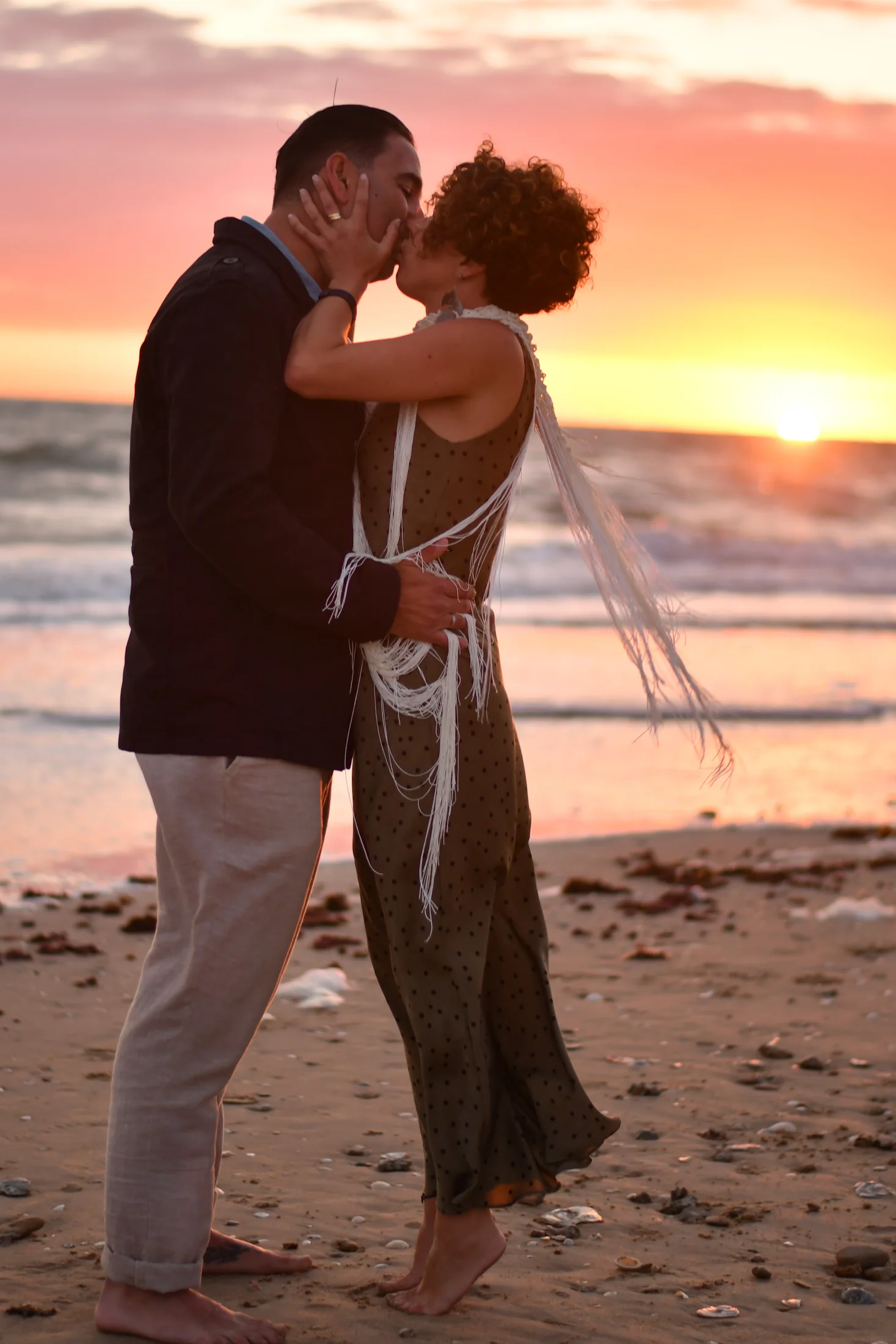 A couple kissing on a Cádiz beach at sunset