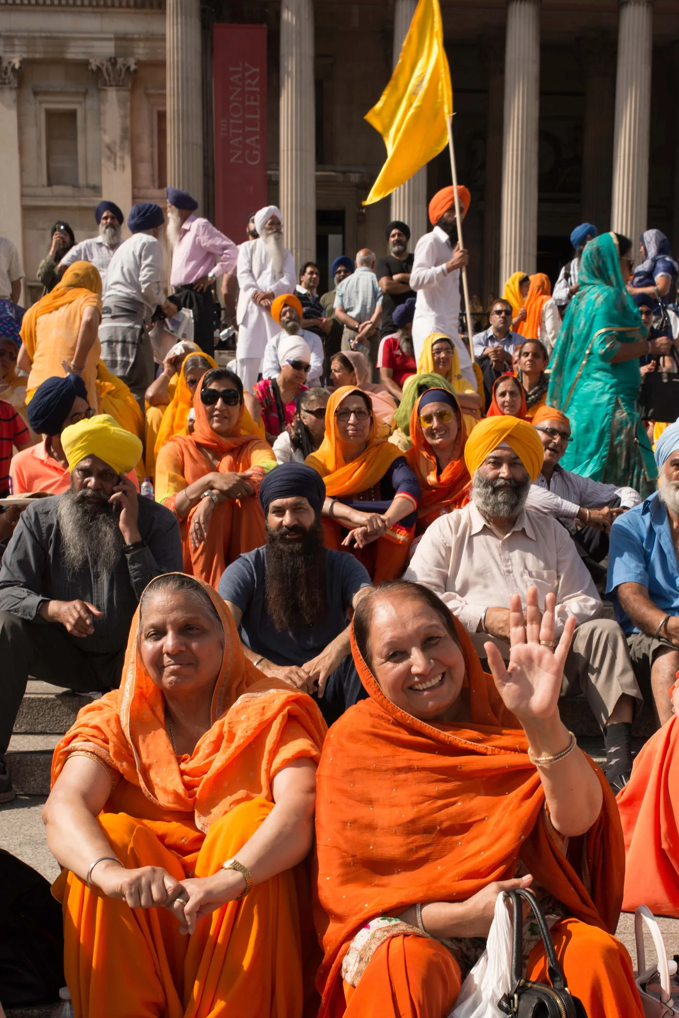 A joyful community gathered in colourful dress